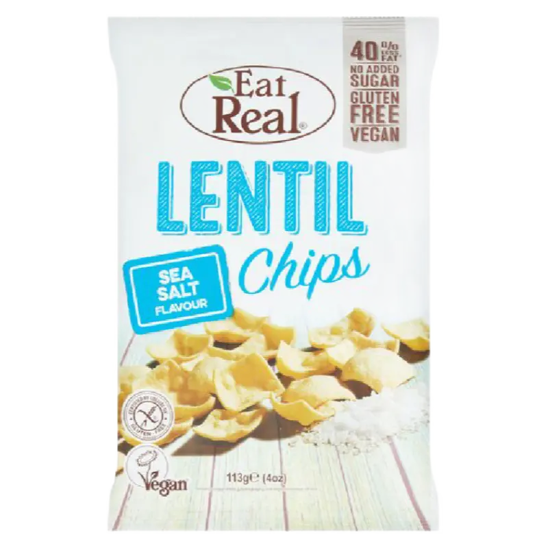 A bag of Eat Real Lentil Chips, Sea Salt Flavour, 113g pack. The white packaging features the Eat Real logo at the top, blue text for 'LENTIL Chips' and 'SEA SALT FLAVOUR', and a photo of golden lentil chips scattered on a light wood background near some salt.