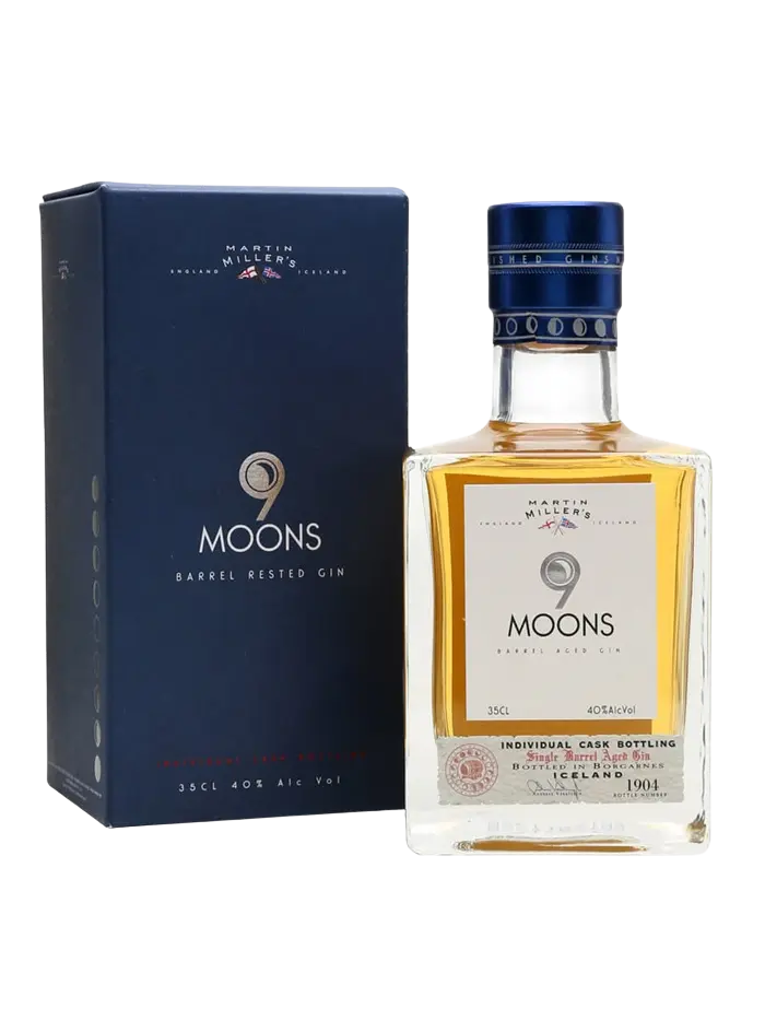 A bottle of Martin Mjolsner 9 Moons Barrel Rested Gin next to its dark blue packaging box, displayed on a clean white background.