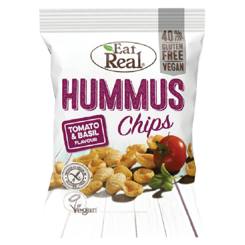 A bag of Eat Real Hummus Chips, Tomato & Basil flavour, on a white background. The packaging is white with purple text and features an illustration of golden-brown chips, a red tomato, and green basil.