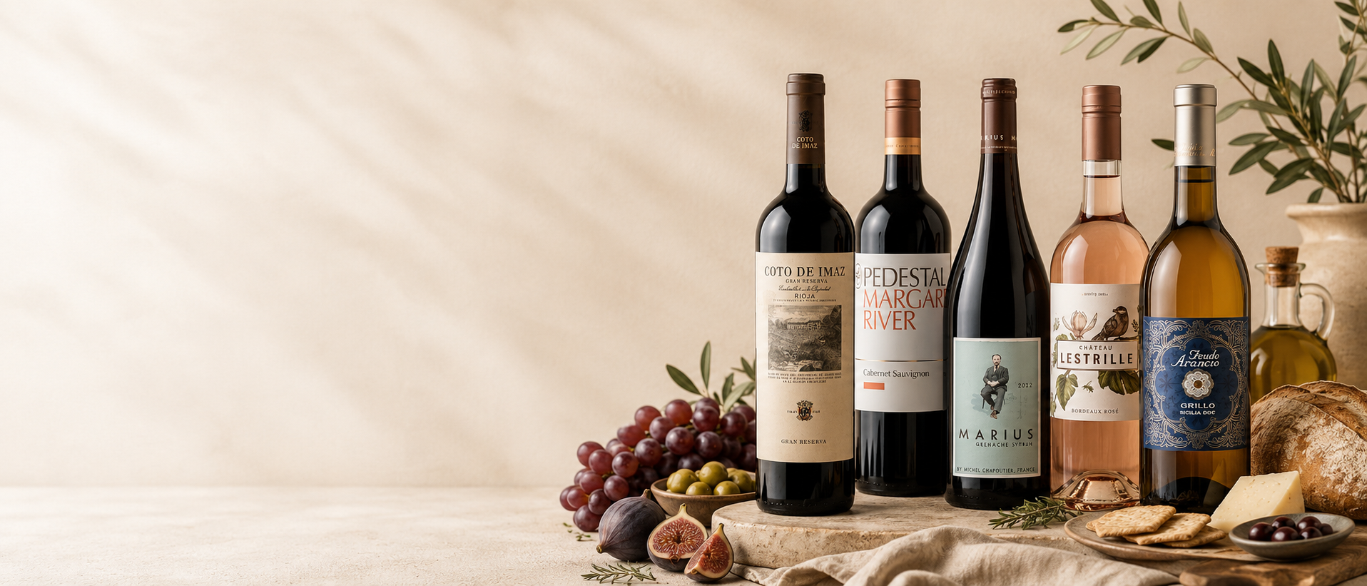 Five wine bottles of various types and colors arranged on a rustic wooden surface with grapes, figs, olives, crackers, and cheese. The bottles include red, white, and rosé wine, with labels such as 'FEDERAL ROYAL CAVES', 'CABERNET SAUVIGNON RESERVE', and 'CABERNET SAUVIGNON'.