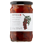 A glass jar of Odyssey Semi-Dried Datterini Tomatoes with a black lid and a white label featuring a red tomato illustration.