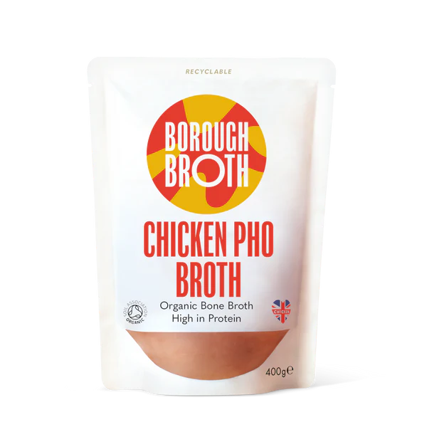 A 400g stand-up pouch of Borough Broth Chicken Pho Broth on a clean white background. The packaging features a white background with a circular red and yellow logo, red text, and a brown broth image at the bottom.